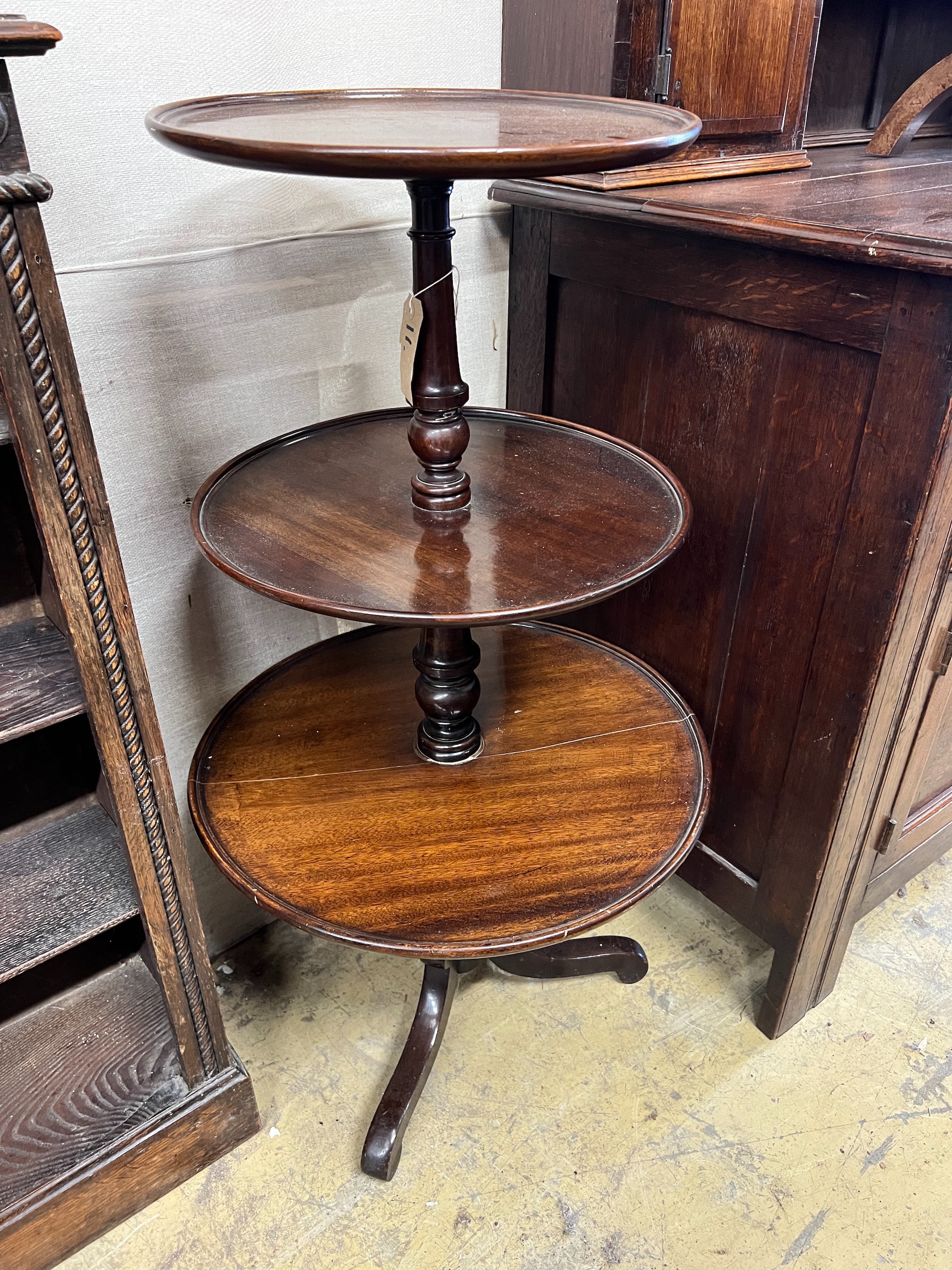 A George III and later mahogany three tier dumb waiter, height 102cm